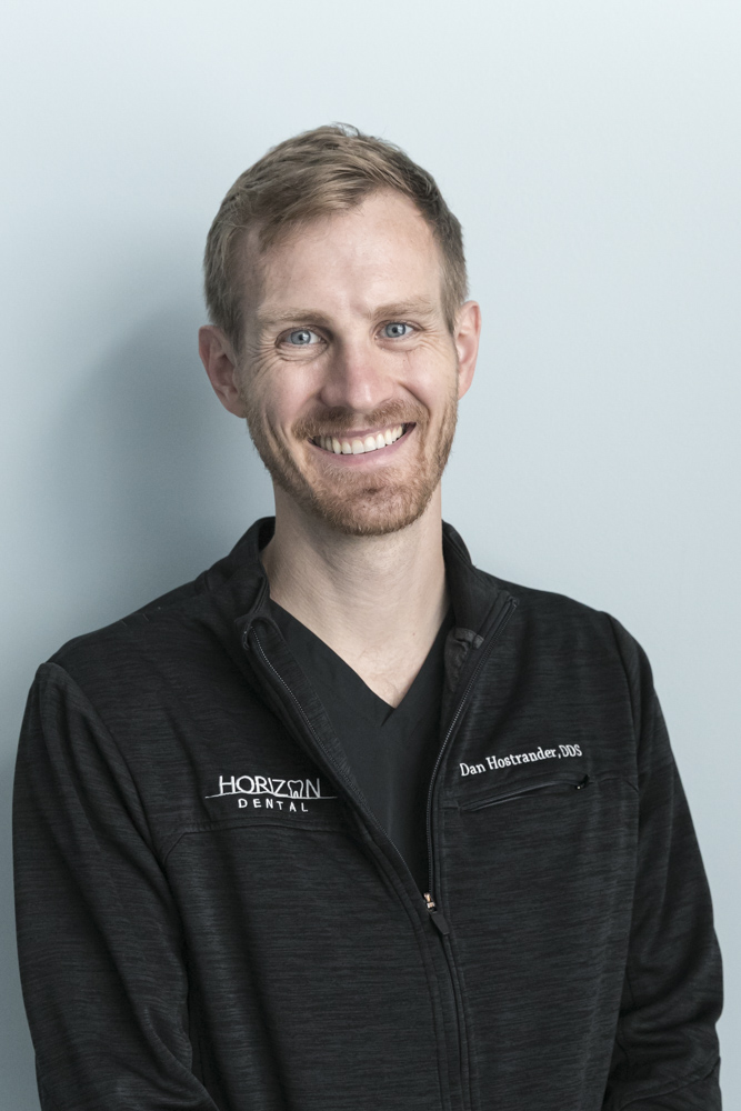 Dr. Dan Hostrander of Horizon Dental headshot smiling with blue background